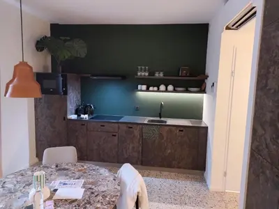 a kitchen with a counter and a sink and a table at Suite Erasmus in Sint-Pieters-Leeuw