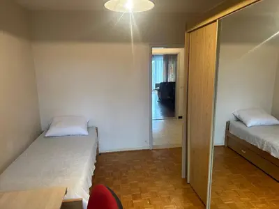 a bedroom with two beds and a door to a hallway at Résidence Europe in Brussels