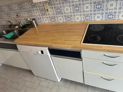 a kitchen with a wooden counter top and a sink at Résidence Europe in Brussels