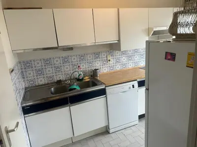 a kitchen with a sink and a refrigerator at Résidence Europe in Brussels
