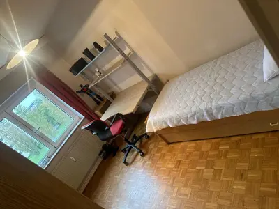 a bedroom with a bed and a window at Résidence Europe in Brussels