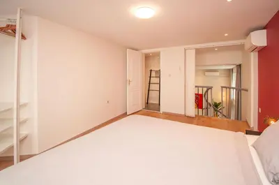 a bedroom with a white bed in a room at Loft in Antwerp City Centre in Antwerp