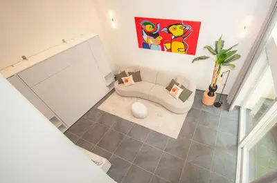 a living room with a couch and a plant at Loft in Antwerp City Centre in Antwerp
