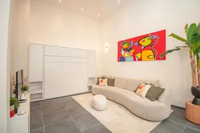 a living room with a couch and a painting on the wall at Loft in Antwerp City Centre in Antwerp