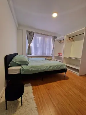 a bedroom with a bed and a window at Le cocon du midi - Appartement Cosy in Brussels