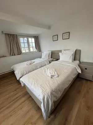 a bedroom with two beds and a window at Hotel La Chaumiere in Asse