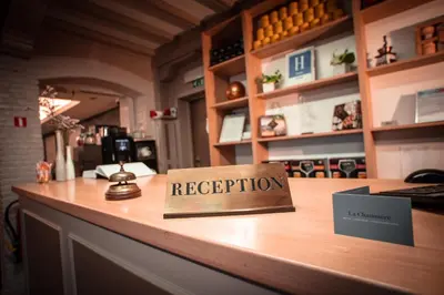a reception desk with a sign that reads reception at Hotel La Chaumiere in Asse