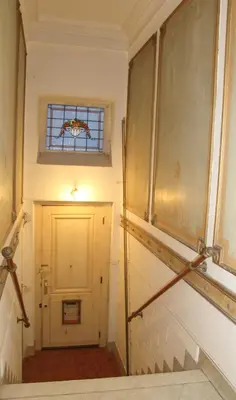 a hallway with a white door and a window at Archimede Guest House in Brussels