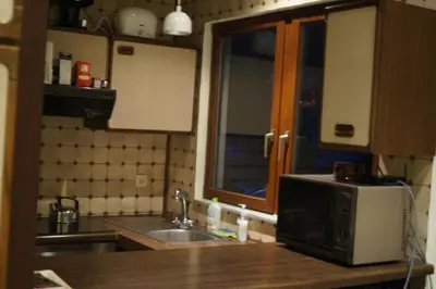a kitchen with a sink and a microwave at Archimede Guest House in Brussels