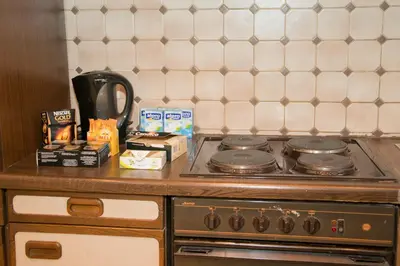 a stove top oven sitting on a counter top at Archimede Guest House in Brussels