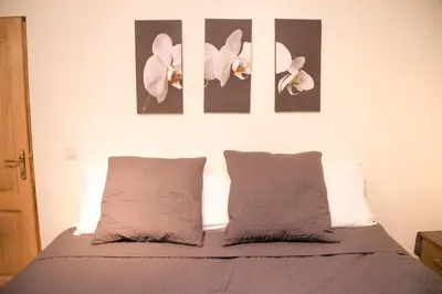 a bedroom with a bed with two flowers on the wall at Archimede Guest House in Brussels