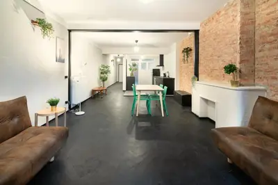 a living room with a couch and a table at Charming and Spacious Apartments in the Heart of Antwerp in Antwerp