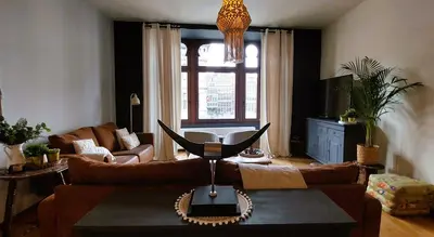 a living room with a couch and a table at Diamond - room with a view in Antwerp
