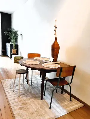 a dining room table with two chairs and a vase at Diamond - room with a view in Antwerp