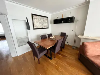a dining room with a table and chairs and a couch at Spacious 2 Bedroom App in the Center with Balcony in Ghent