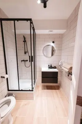 a bathroom with a shower and a sink and a toilet at K-suites in Brussels
