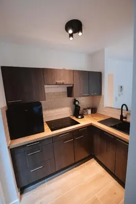 a kitchen with wooden cabinets and a counter top at K-suites in Brussels