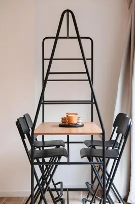 a table and chairs with a metal shelf at K-suites in Brussels