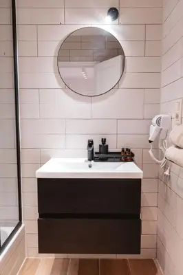 a bathroom with a sink and a mirror at K-suites in Brussels