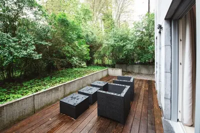 a row of benches sitting on a wooden deck at K-suites in Brussels