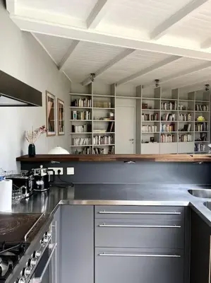a kitchen with white cabinets and a counter top at Charmante maison dans un coin de verdure à Boitsfort in Brussels