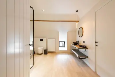 a bathroom with a sink and a desk in a room at Huis Velzeke in Zottegem