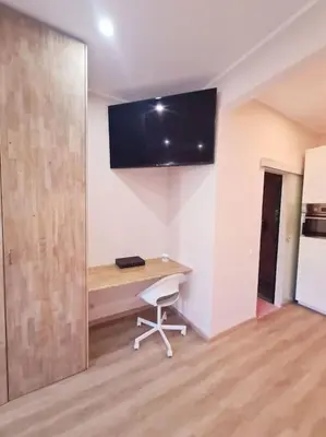 a room with a desk and a tv on the wall at Magnolia Pink Studio New and fully equipped in Brussels
