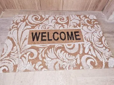 a welcome rug on a floor with a welcome sign at Magnolia Pink Studio New and fully equipped in Brussels