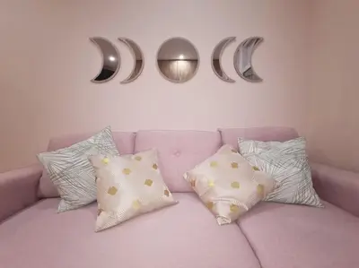a pink couch with pillows and mirrors on a wall at Magnolia Pink Studio New and fully equipped in Brussels