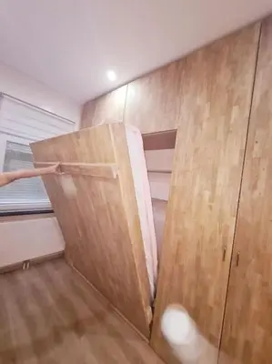 a room with a closet with a wooden door at Magnolia Pink Studio New and fully equipped in Brussels