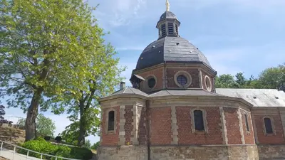 an old brick church with a steeple on top at B&B Krieken de Jour in Ninove