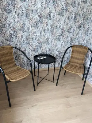two chairs and a table in front of a wall at B&B Krieken de Jour in Ninove