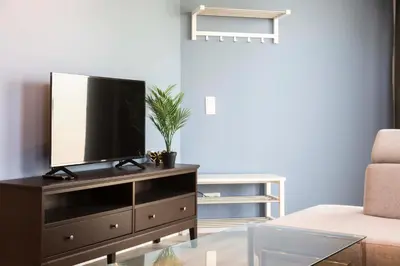a living room with a flat screen tv on a dresser at Brussels EU Design Residence in Brussels