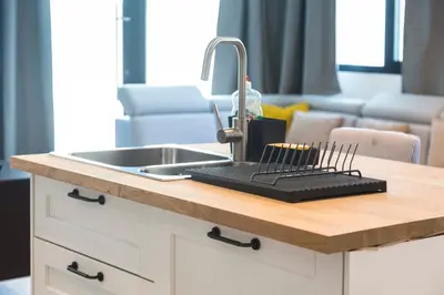 a kitchen counter with a sink and a tray with a candle at Brussels EU Design Residence in Brussels