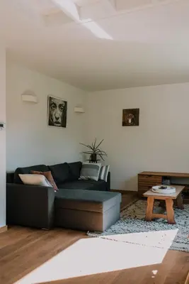 a living room with a couch and a table at Vakantiehuis De Bekaf in Stekene