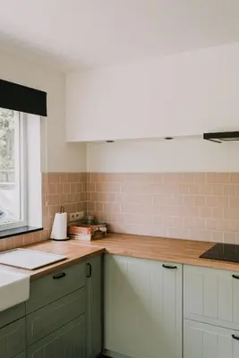 a kitchen with white cabinets and a counter top at Vakantiehuis De Bekaf in Stekene
