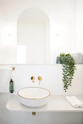 a white bathroom with a bowl sink on a counter at WoW in Brussels