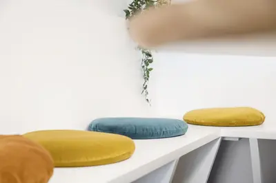 three pillows sitting on a white shelf at WoW in Brussels