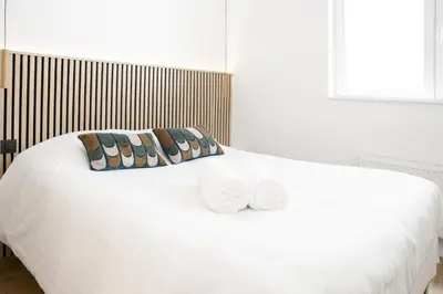 a white bed with two pillows on top of it at WoW in Brussels
