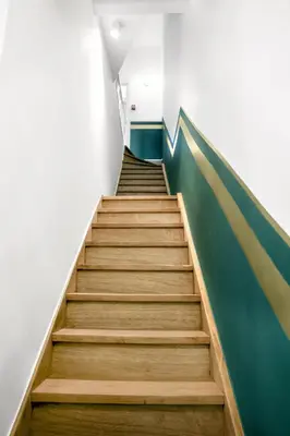 a staircase with a green wall and wooden steps at WoW in Brussels