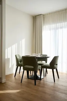 a dining room with a table and chairs at Georges Henri Aparthotel in Brussels