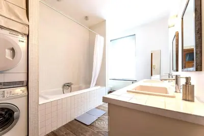 a bathroom with a sink and a washing machine at Spacious apartment in Brussels, large private garden in Brussels
