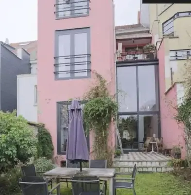 an umbrella sitting on a table in front of a building at Spacious apartment in Brussels, large private garden in Brussels