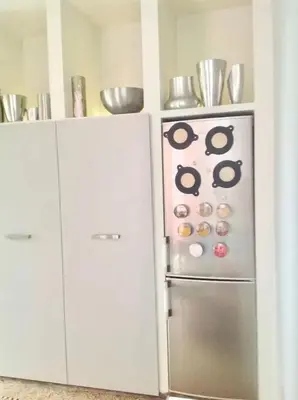 a kitchen with white cabinets and a stainless steel refrigerator at Spacious apartment in Brussels, large private garden in Brussels