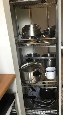 a shelf full of pots and pans in a kitchen at Spacious apartment in Brussels, large private garden in Brussels