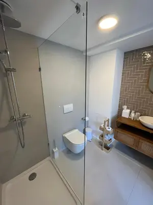 a bathroom with a shower with a toilet and a sink at Business Accommodation 'Natural Living' Nomad in Geel