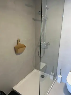 a shower with a glass door in a bathroom at Business Accommodation 'Natural Living' Nomad in Geel
