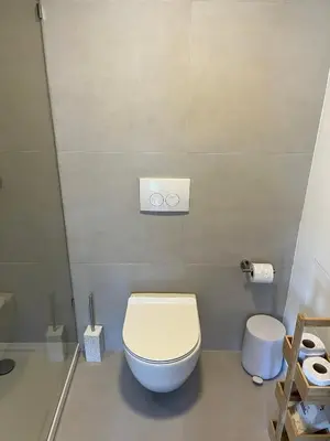 a bathroom with a white toilet in a room at Business Accommodation 'Natural Living' Nomad in Geel