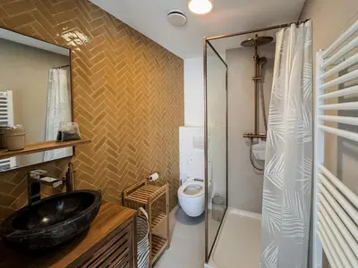 a bathroom with a sink and a shower and a toilet at Business Accommodation 'Scandinavian Living' Nomad in Geel