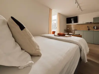 a bedroom with a large white bed with pillows at Business Accommodation 'Scandinavian Living' Nomad in Geel